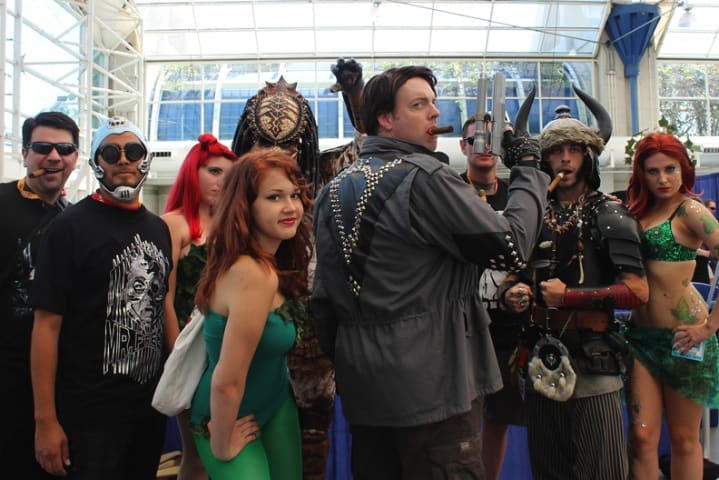 Ryan Vera (far left) sneaks into a photo of Schwarzenegger fans at Comic Con.
