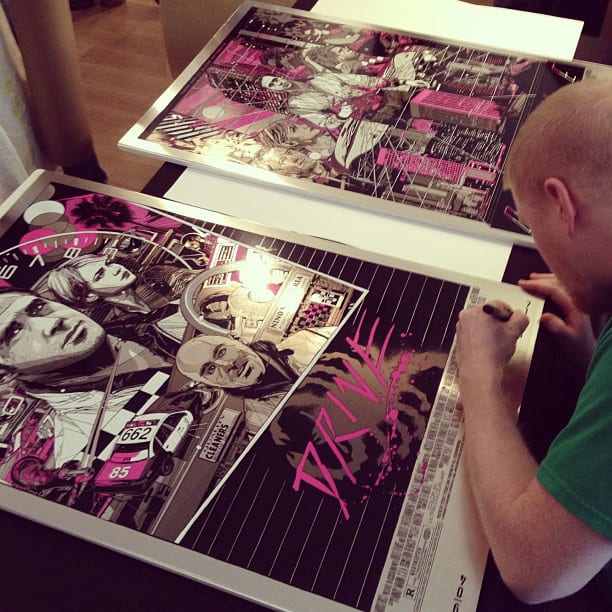 Tyler Stout signing his 'Drive' posters for Mondo. (unknown photographer)