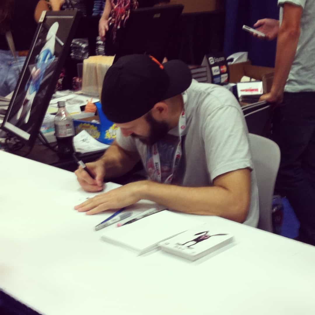 Alex Pardee signing and doodling at the ZeroFriends booth.