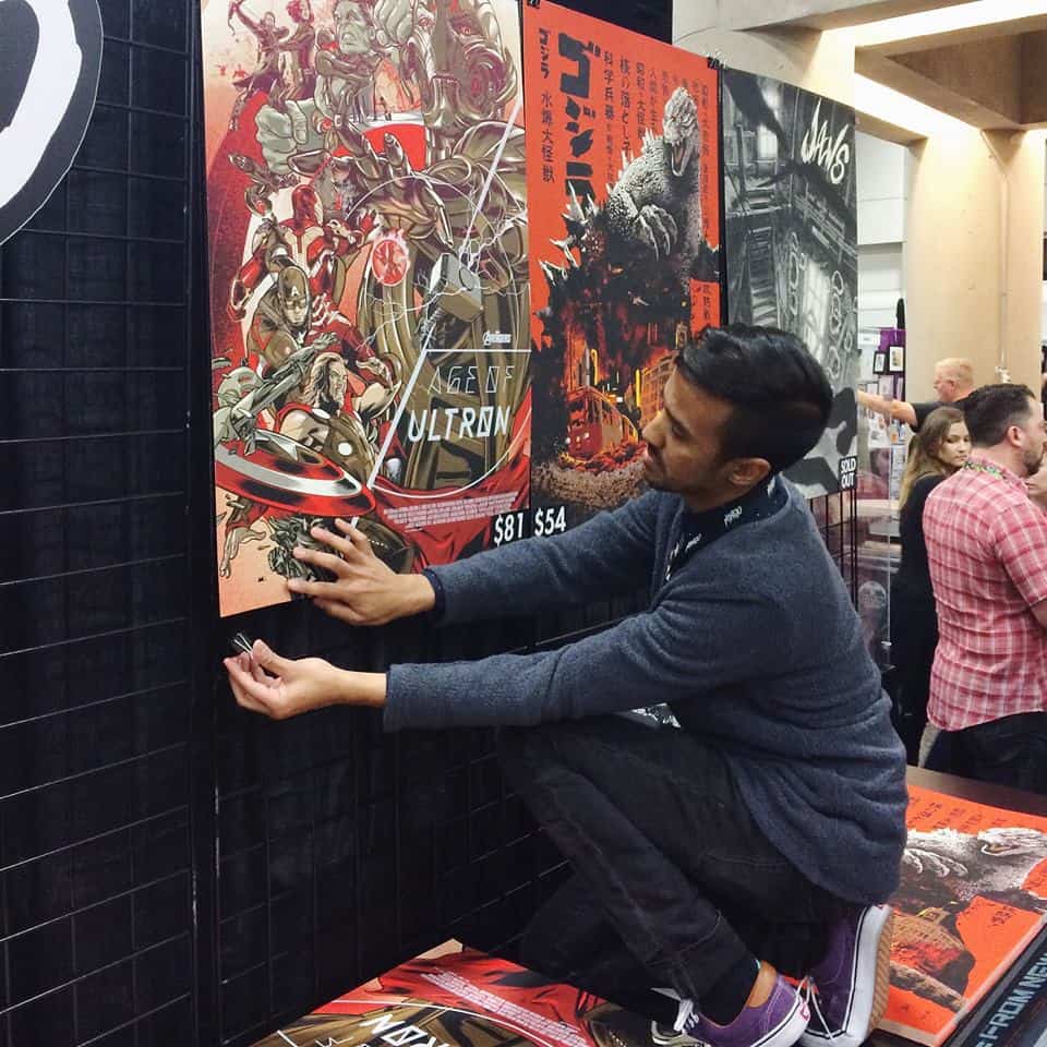 Mo Shafeek hanging posters in the Mondo Booth at San Diego Comic Con 2015 | Photo by Mary Rose Wiley